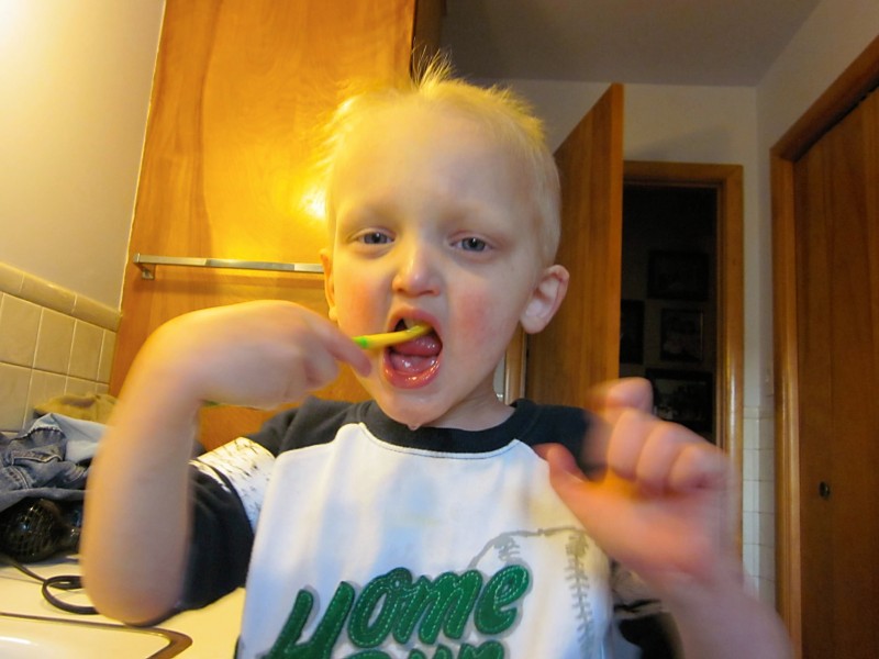 Keegan brushes his tooth.