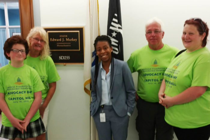 Beth and Michael Pond and another NFED family stand with a member of the staff of Senator Edward Markey