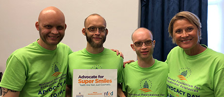 A group of NFED members holding a sign to advocate for smiles