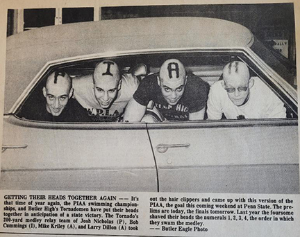 This is a newspaper article showing four teenagers with their heads out of the car window. Each had shaved their heads to spell out the letters P-I-A-A.