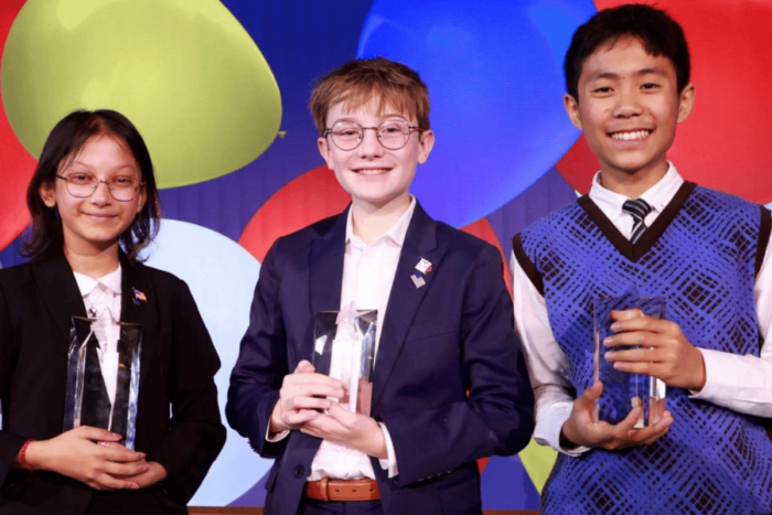 Emily and two boys hold their awards at the National Civics Bee.