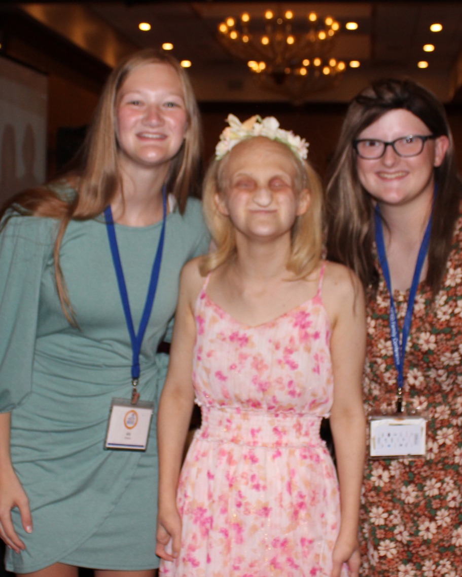 Picture of Ally with two friends as a young adult