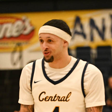 Jacobi is wearing a white headband and smiling.