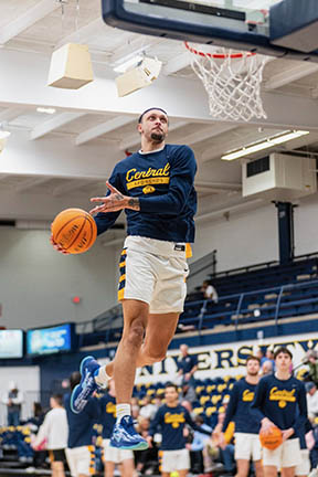 Jacobi shoots in a game while players and crowd watch.