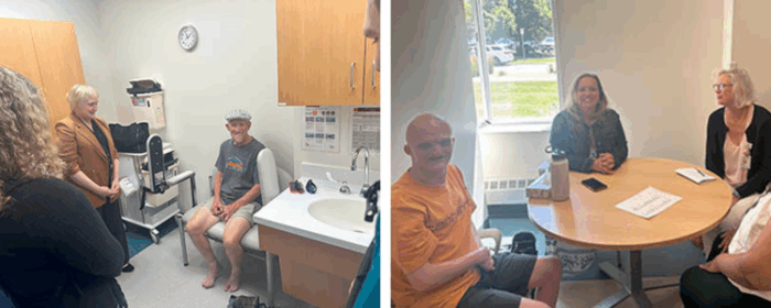 A man wearing a hat and no shoes is sitting in a hospital examination room while three people are standing and examining his feet. His feet are missing toes due to ectrodactyly.