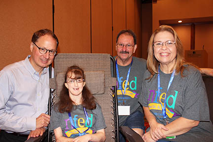 Dr. Stanford is sitting next to a young woman affected by Goltz syndrome. Her parents sit on the other side.