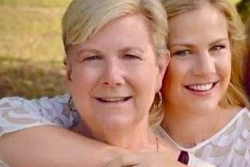 Lindsey stands behind her mom with her arms wrapped around her shoulders.