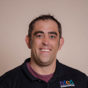 head shot of Greg Klimovitz who is wearing a black NFED polo shirt.