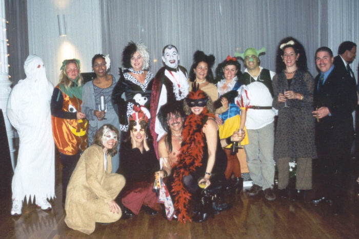 A large group of people are wearing Halloween costumes at the Halloween Bash.