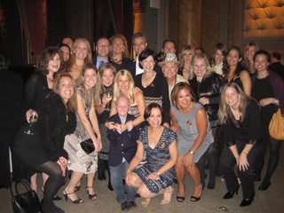 A large group of people post at the Halloween Bash cocktail party.