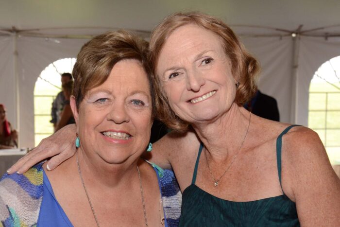 Mary Kaye and Mary have their arms around each other at a gala.
