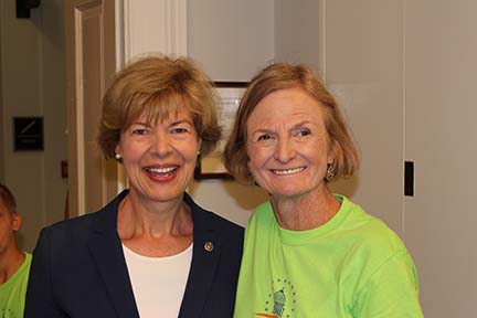 Mary stands shoulder to shoulder with the Senator.