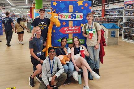 A group of teenagers pose at the Toys R Us Store at the Mall of America. They are on a field trip at the NFED Teens Program. 