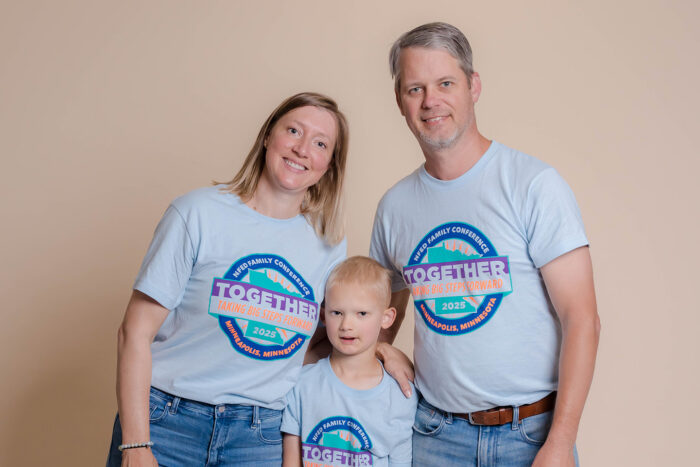 A mom and dad pose with their son by putting their arms around him. Parents can be a great support for children if they are experiencing bullying due to ectodermal dysplasias.