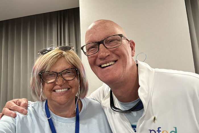 A man has his arm around a woman. 