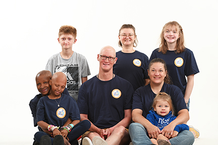 Eight people pose for a photo. All are affected by various types of ectodermal dysplasias.